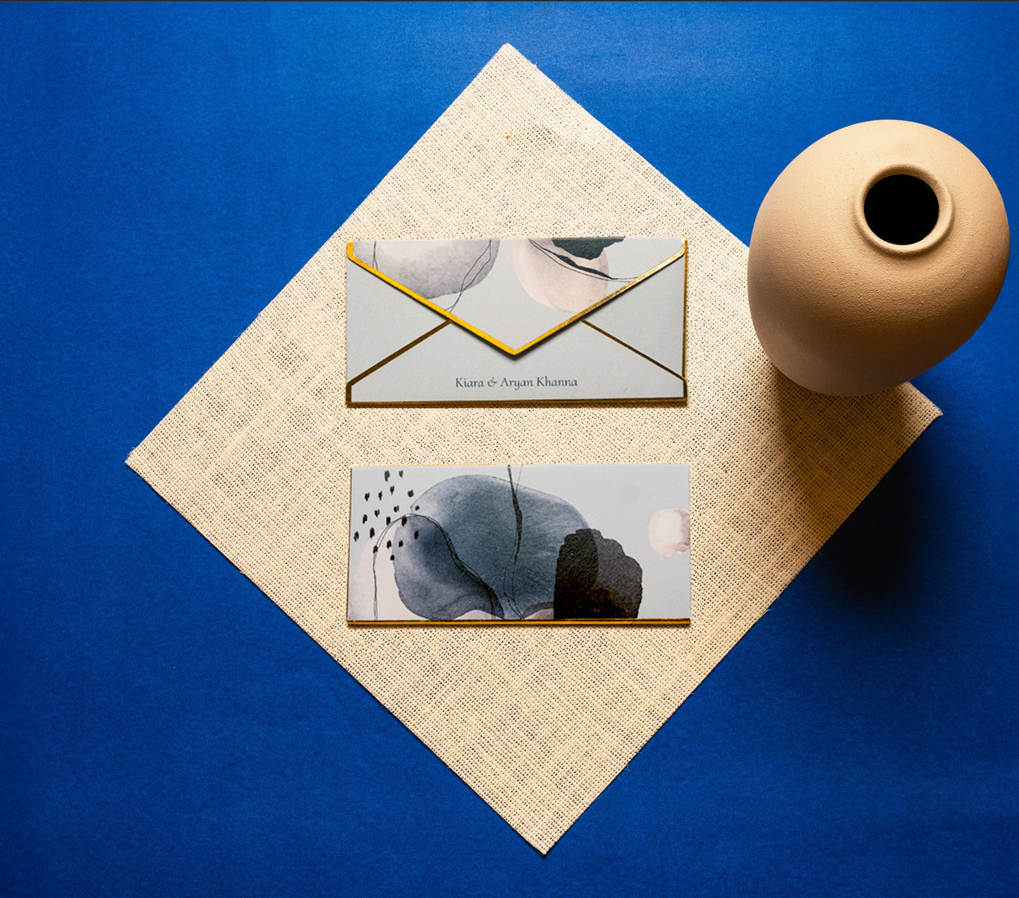 Celeste money envelope; box envelope with a grey, black and white abstract print on a blue background and gold foiled edges
