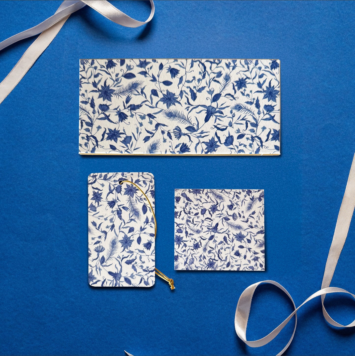 A money envelope, hanging tag and folded card, all in the same blue and white floral print