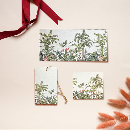 A money envelope, hanging tag and folded card, all in the same tropical jungle print on a white background