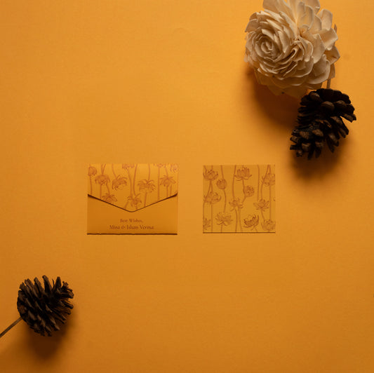 Safira notecard; a card with line drawing lotus pattern on a yellow-orange background paired with a matching small envelope