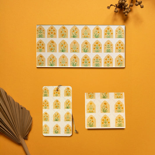 A money envelope, hanging tag and folded card, all in the same geometric pattern of mughal flowers within arches
