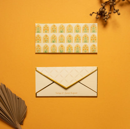 Solenne money envelope; box envelope with a geometric pattern of mughal flowers within arches and gold foiled edges
