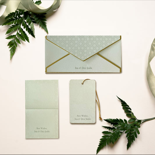 A money envelope, hanging tag and folded card, all in the same pichwai inspired jungle illustration on a green background